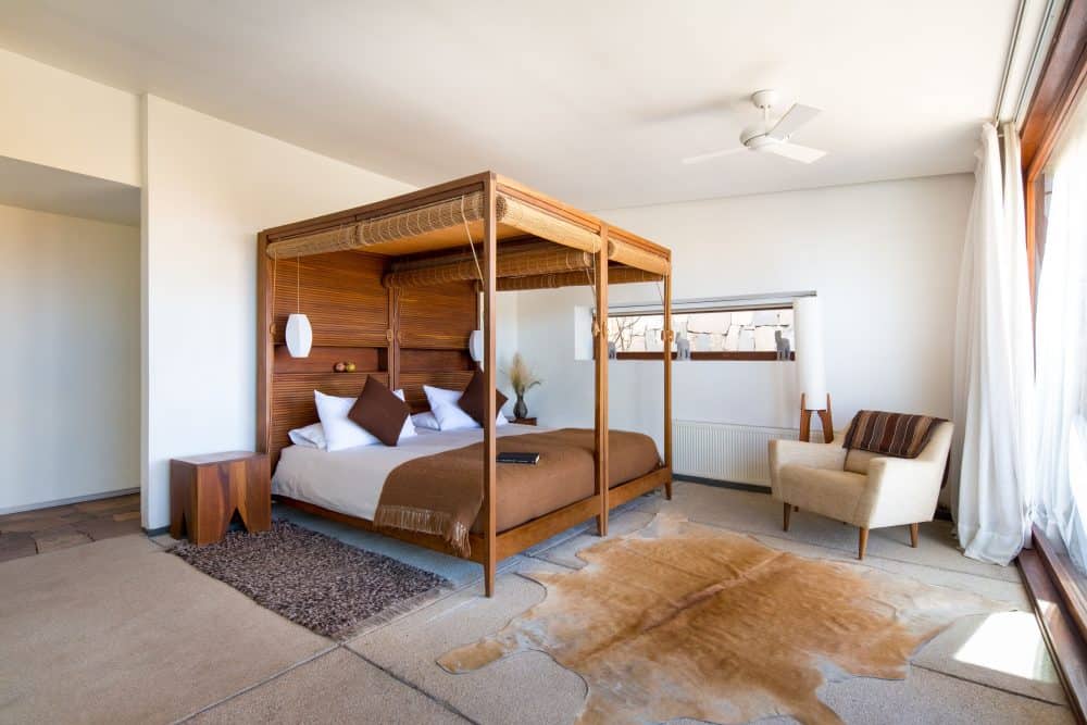 View of the inside of Tierra Atacama's Oriente room featuring airy decor and canopy bed.