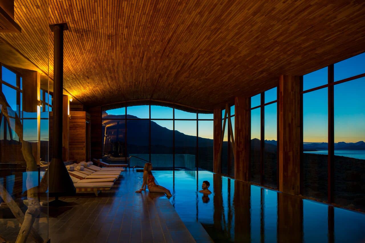 Couple sitting by the indoor pool at Tierra Patagonia's spa.