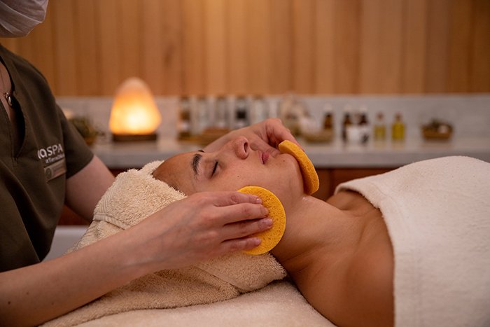 A woman enjoys a facial spa treatment at the Uma Spa by Tierra Hotels.